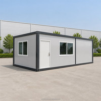Cabine modulaire portable avec panneaux muraux gris, porte et fenêtres à cadre foncé pour bureau de jardin ou salle d'employés