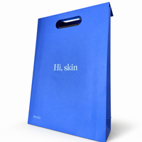 Sac en papier bleu Klein avec poignée découpée pour les boutiques de soins de la peau, les salons de beauté et les marques de cosmétiques, impression de logo personnalisée