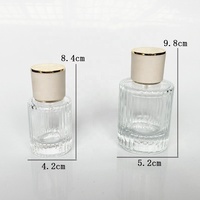 Flacon de parfum cylindrique vide 30ml/50ml en verre transparent cristallin avec mécanisme de pulvérisation par pression pour transfert de parfum