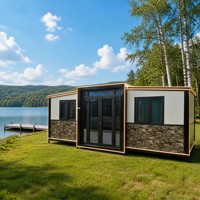 Maison modulaire préfabriquée moderne, maison préfabriquée à ossature en acier noir, maison en kit, bande lumineuse LED, mur en placage de pierre, cour arrière
