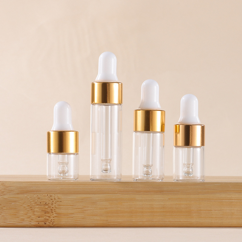 Tapa cuentagotas transparente + dorada + Tetina blanca