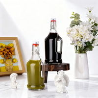 Bouteille en verre vide ronde pour jus de fruits, lait, boissons, avec couvercle à rabat et poignée