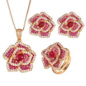 Parure de bijoux de mariée délicate et écologique en cuivre plaqué or avec zircon rouge pavé, motif floral doré, comprenant collier et boucles d'oreilles - Product Image 1