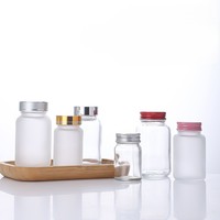 Vente en gros de pots de stockage de pilules en verre transparent givré de petite capacité 60cc 75cc 100cc avec couvercles à vis pour capsules, comprimés de vitamines
