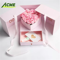 Vente en gros de boîte cadeau de fleurs rondes en carton cylindrique noir de luxe personnalisée pour fleurs avec traitement d'impression de gaufrage