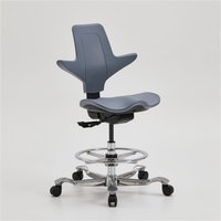 Protecteur orthopédique de colonne vertébrale de selle Chaise d'équitation ergonomique Tabouret de selle d'équitation de dentiste Chaise pivotante roulante Chaises moussantes en PU