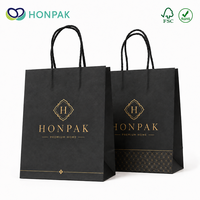 Sac de shopping en papier kraft noir de luxe personnalisé avec poignée torsadée et logo doré pour emballage cadeau de boutique HONPAK