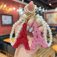 Élégant porte-clés tour Eiffel avec strass et fausse perle, accessoire tendance pour sac à main, pendentif pour femme