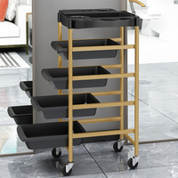 Chariot de rangement multifonctionnel moderne noir et or pour salon de manucure, équipement de coiffure et de beauté, avec roulettes