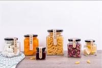 Vente en gros d'emballage de pots de miel pot de conserve carré bouteille vide mini pots de confiture de miel en verre carré avec couvercles noirs