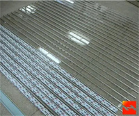 Porte à enroulement moderne en alliage d'aluminium argenté personnalisée avec commande facile pour immeuble de bureaux