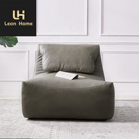 Mobilier de salon italien moderne et léger et luxueux Chaise longue de loisirs en cuir avec repose-pieds