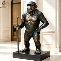 Statue de gorille grandeur nature en fibre de verre finition bronze, sculpture de chimpanzé aux bras croisés pour la décoration de hall d'hôtel, villa, bureau