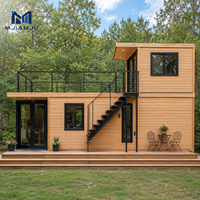 Maison préfabriquée modulaire moderne en acier à deux étages avec balcon et escalier en colimaçon pour un salon élégant