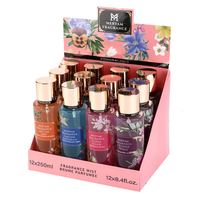 Brume Corporelle Parfumée pour Femme – Flacon Cylindrique Violet avec Capuchon Doré, Motif Floral Étoile de Mer et Ruban – Collection Été Briseée Longue Durée