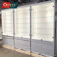 Vitrine de présentation de lunettes OUYEE personnalisée en verre pour magasin d'optique, présentoir mural pour lunettes de soleil