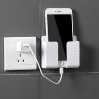 Soporte de pared adhesivo para teléfono móvil, cargador de pared y soporte para control remoto, popular y nuevo en el mercado.