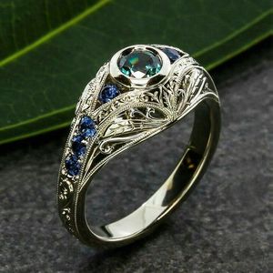 Anillo de compromiso de moda para mujer H217 con gema de zafiro, engaste de bisel, piedra natural redonda y diseño de plantas - Product Image 1