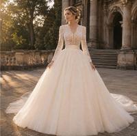 Robe de mariée de luxe moderne, style princesse, longue jusqu'au sol, col en V, manches longues, avec appliques en dentelle, traîne chapelle, en tulle scintillant