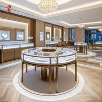 Luxuriöses Rundes Schmuck-Präsentationsinsel-Set Gebogene Glasvitrine mit LED-Beleuchtung Gebürstetes Gold Boutique-Einzelhandelsmöbel