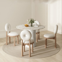 Ensemble de table à manger circulaire en terrazzo de luxe avec chaise à piétement cannelé et dossier torique, design moderne pour hôtel et villa