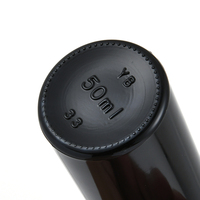 Vente en gros de petites bouteilles en verre noires de forme ronde, écologiques, avec couvercles, personnalisables avec un logo gravé, pour cosmétiques