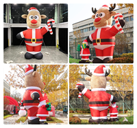 Élan en peluche gonflable personnalisé en costume de Père Noël tenant une canne à bonbons pour décorations de Noël