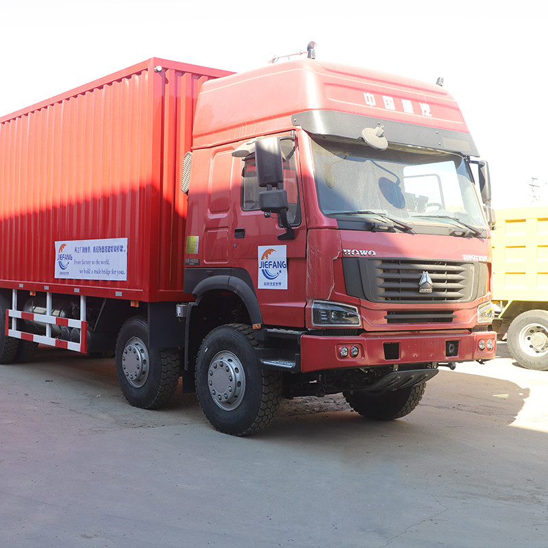 Howo 371 red dump truck equipped with HW15710 transmission for material handling at construction sites