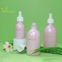 Flacon compte-gouttes d'essence en verre de 100ml de décoration personnalisée nouveau fabricant de Chine impression en spray scintillant et feuille rose couleur