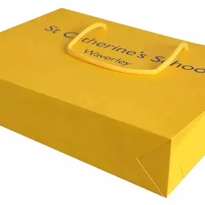Saco de papel amarelo impresso personalizado para compras em boutique com alça luxuosa