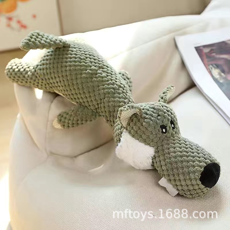 Chien loup couché + jouet couineur pour animal de compagnie