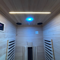 Sauna finlandais extérieur en forme de maison noire avec poêle électronique, design moderne et écologique, en bois, avec toit pour jardin
