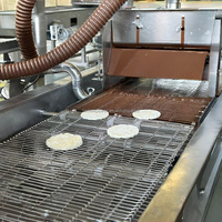 Ligne de production entièrement automatique pour l'enrobage et le tempérage du chocolat, destinée aux amandes, noix de cajou, cacahuètes et biscuits