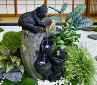 Deux sculptures d'ours noirs en résine avec fontaine à eau et lumières LED pour la décoration de jardin