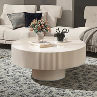 Table basse de style européen moderne, design tambour cannelé, plateau en pierre à bords embossés, structure en bois, piétement durable, table centrale blanche