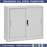 Armoire de rangement compacte en acier gris à portes coulissantes, idéale pour le bureau, la maison, le garage ou l'atelier