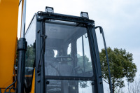 Excavatrice sur roues de 14 tonnes, conception anti-blocage par les pierres avec pneus jumeaux, transmission intégrale permanente, garde au sol de 384 mm