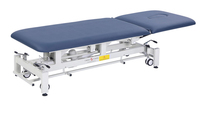 Table de massage électrique portable réglable en hauteur en acier inoxydable avec revêtement en PU et système de repose-pieds pliable pour traitement professionnel