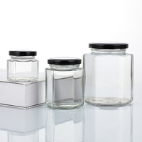 Pot en verre hexagonal de haute qualité avec décalcomanie pour le stockage du miel, de la sauce piquante, de la pâte de citron, des gâteaux, du chocolat, des bonbons, de la gelée, résistant aux hautes températures, en carton