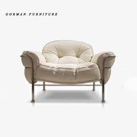 Fauteuil de loisirs Gorman en cuir de style luxueux avec coussin confortable en éponge et structure en acier inoxydable, canapé individuel avec ottoman