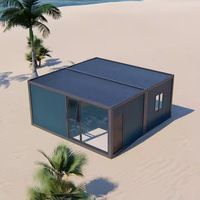 Maison de plage modulaire préfabriquée de luxe en acier avec façade vitrée, vue sur l'océan, assemblage rapide, cabane portable