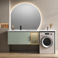 Meuble-lavabo moderne vert sauge avec lavabo, miroir LED rond mural, armoire de buanderie et espace pour machine à laver, idéal pour projets hôteliers
