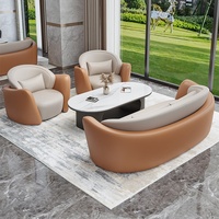 Ensemble de canapés commerciaux haut de gamme en cuir noir et marron avec table basse en marbre, mobilier pour hall d'hôtel