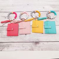Portefeuille à bracelet en perles de silicone, porte-cartes, porte-clés en cuir PU, porte-clés à pompon, porte-monnaie pour femme, porte-clés à bracelet