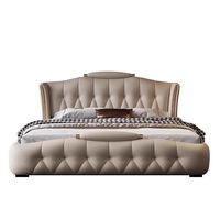 Lit double moderne de luxe capitonné en cuir véritable avec tiroirs de rangement latéraux et garniture en métal doré pour chambre principale