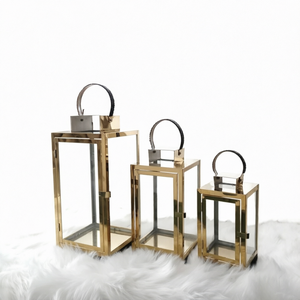 Modern Gold Stainless Steel Glass Candle <b>Lantern</b> <b>Set</b> (<b>Set</b> of 3) home decor with this luxurious Modern Gold Stainless Steel Glass - Product Image 1