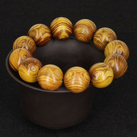 Bracelets en bois doré avec visage de fantôme et paire d'yeux