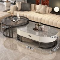Ensemble de tables basses modernes rondes et ovales imbriquées avec tiroir de rangement, plateau en pierre frittée et structure métallique pour l'ameublement de la maison