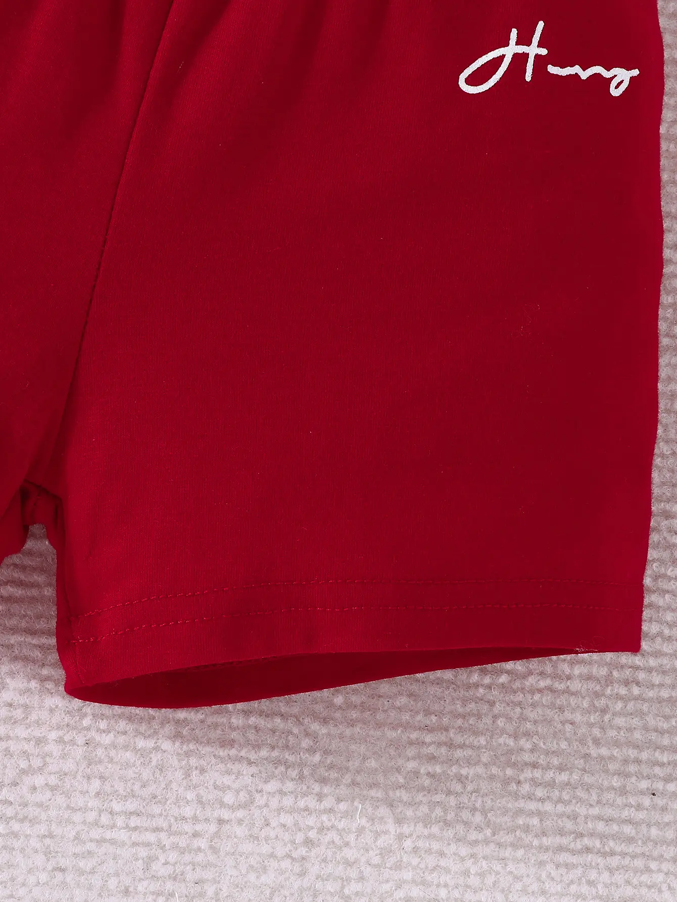 The popular baby and children's red T-shirt and shorts set is made of polyester material which is soft and comfortable