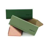 Vente en gros de nouveaux étuis à lunettes portables en cuir PU étui à lunettes de soleil pliable en forme de triangle pour lunettes